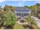 Beautiful home in a treed lot, featuring an elevated porch, landscaped lawn, and large windows at 3734 St Ellens Dr, Mount Pleasant, SC 29466