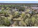Aerial view of neighborhood homes, lush trees, and pond at 3734 St Ellens Dr, Mount Pleasant, SC 29466