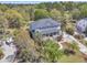 Stunning aerial view of a light blue two-story home surrounded by lush greenery and mature trees in a desirable neighborhood at 3734 St Ellens Dr, Mount Pleasant, SC 29466