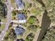 Aerial shot featuring backyard bordering the lake, of home with mature trees, lush lawns, and surrounding neighborhood at 3734 St Ellens Dr, Mount Pleasant, SC 29466