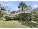 Backyard view of home with a large deck, screened porch, mature landscaping, and palm tree at 3734 St Ellens Dr, Mount Pleasant, SC 29466
