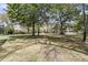 Large grassy backyard with mature trees providing ample shade and beautiful views of the neighborhood at 3734 St Ellens Dr, Mount Pleasant, SC 29466
