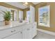 Bright bathroom featuring white cabinetry, a large mirror, granite countertops and a window that provides natural light at 3734 St Ellens Dr, Mount Pleasant, SC 29466