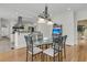 Bright dining room features hardwood floors, elegant chandelier, and access to a modern kitchen at 3734 St Ellens Dr, Mount Pleasant, SC 29466