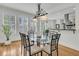 Dining room with a glass table, hardwood floors and large windows with bright light at 3734 St Ellens Dr, Mount Pleasant, SC 29466