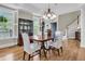 Well-lit dining room with hardwood floors, a chandelier, and stylish decor, perfect for Gathering meals at 3734 St Ellens Dr, Mount Pleasant, SC 29466