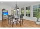 Dining room with a glass table, hardwood floors and large windows with bright light at 3734 St Ellens Dr, Mount Pleasant, SC 29466