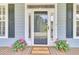 Welcoming front door with sidelights, a 'Welcome Home' mat, and potted plants at 3734 St Ellens Dr, Mount Pleasant, SC 29466