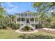 Charming two-story home with a grand entrance, white railings, and a beautifully landscaped front yard at 3734 St Ellens Dr, Mount Pleasant, SC 29466