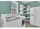 Functional laundry room with white washer and dryer, storage baskets, and a large window for natural light at 3734 St Ellens Dr, Mount Pleasant, SC 29466