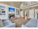 Bright living room with a stone fireplace, built-in cabinets, and an open design to the upstairs landing at 3734 St Ellens Dr, Mount Pleasant, SC 29466