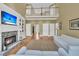 Spacious living room with stone fireplace, built-in shelves, soaring ceilings, and abundant natural light at 3734 St Ellens Dr, Mount Pleasant, SC 29466