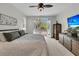 Bright main bedroom featuring a ceiling fan, carpet, and doors to a balcony at 3734 St Ellens Dr, Mount Pleasant, SC 29466