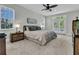 Bright main bedroom featuring a ceiling fan, carpet, and doors to a balcony at 3734 St Ellens Dr, Mount Pleasant, SC 29466