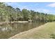 Picturesque view of a tranquil pond surrounded by lush greenery at 3734 St Ellens Dr, Mount Pleasant, SC 29466