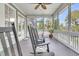 Relaxing screened porch featuring black rocking chairs and views of lush greenery at 3734 St Ellens Dr, Mount Pleasant, SC 29466