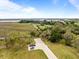 Aerial view featuring a home, marshland, a dock, and a cart parked nearby at 377 Lofton Ct, McClellanville, SC 29458