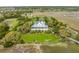 Beautiful aerial view of home nestled in mature trees with a metal roof and lush green lawn at 377 Lofton Ct, McClellanville, SC 29458
