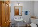Classic bathroom with pedestal sink, charming fixtures, and wood accents, evoking timeless elegance and comfort at 377 Lofton Ct, McClellanville, SC 29458
