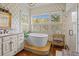 Serene bathroom featuring a freestanding tub, natural light, and stylish fixtures, creating a spa-like atmosphere at 377 Lofton Ct, McClellanville, SC 29458