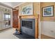 Bedroom showcasing a charming fireplace, seamlessly connecting to an outdoor balcony with picturesque waterfront scenery at 377 Lofton Ct, McClellanville, SC 29458