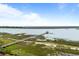 Dock on water with wooden walkway out to the gazebo and small seating area on the water at 377 Lofton Ct, McClellanville, SC 29458