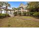 Exterior view of the house with palm trees, a gazebo and brick walkway to the home at 377 Lofton Ct, McClellanville, SC 29458