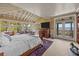 Sunlit main bedroom with water views, complemented by a comfortable sitting area and private balcony access at 377 Lofton Ct, McClellanville, SC 29458