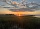 Beautiful sunset reflecting on a marshland view at 377 Lofton Ct, McClellanville, SC 29458