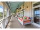 Spacious porch with a swing, comfortable seating, and ample room for relaxation and enjoying the outdoors at 377 Lofton Ct, McClellanville, SC 29458