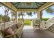 Inviting porch featuring a swing, rocking chair, and a picturesque view of the outdoors and waterfront at 377 Lofton Ct, McClellanville, SC 29458