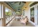Expansive porch with cozy seating, ceiling fans, and an inviting space for outdoor living and entertainment at 377 Lofton Ct, McClellanville, SC 29458
