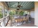 Welcoming porch with a dining table, chairs, and a peaceful setting for outdoor meals and gatherings at 377 Lofton Ct, McClellanville, SC 29458