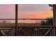 Screened porch view of waterfront with marshland and private docks during a colorful sunset at 377 Lofton Ct, McClellanville, SC 29458