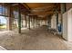 View under house showing gravel floor, wooden beams and a ladder at 377 Lofton Ct, McClellanville, SC 29458
