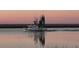 White and black fishing boat at sunset reflecting in the water at 377 Lofton Ct, McClellanville, SC 29458