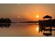 Golden sunset reflecting on calm waters with a dockside gazebo at 377 Lofton Ct, McClellanville, SC 29458