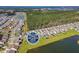 An aerial view of the neighborhood homes lining a pond with lush trees beyond at 400 Dunlin Dr, Summerville, SC 29486