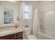 Bathroom with granite countertops, white cabinets, and tiled shower and tub at 400 Dunlin Dr, Summerville, SC 29486