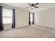 Spacious bedroom features neutral carpeting, ceiling fan, and natural light from two windows at 400 Dunlin Dr, Summerville, SC 29486