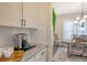 Dining room with modern white cabinets and appliances and a dining room table at 400 Dunlin Dr, Summerville, SC 29486