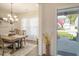 Cozy dining room with natural light, elegant chandelier, and view of the front yard at 400 Dunlin Dr, Summerville, SC 29486