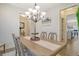Bright dining room featuring a large table, elegant lighting, and a view into the kitchen at 400 Dunlin Dr, Summerville, SC 29486