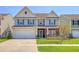 A well-manicured lawn complements this stylish two-story home with a two-car garage at 400 Dunlin Dr, Summerville, SC 29486