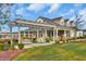 Charming home exterior featuring a covered porch, pergola and manicured landscaping, creating a welcoming outdoor space at 400 Dunlin Dr, Summerville, SC 29486