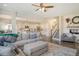 Spacious open concept living room with hardwood floors, grey sofa, and open staircase at 400 Dunlin Dr, Summerville, SC 29486