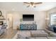 Living room with sofa, console, television, and view to the yard at 400 Dunlin Dr, Summerville, SC 29486