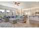 Open-concept living room with modern furniture, hardwood floors, and access to dining and kitchen areas at 400 Dunlin Dr, Summerville, SC 29486