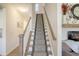 Carpeted staircase leading to upstairs of home, next to fireplace and decor at 400 Dunlin Dr, Summerville, SC 29486