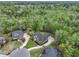 Overhead shot of a red brick house with pristine landscaping, complemented by a dense woodland backdrop at 4204 Magnolia Ct, North Charleston, SC 29420